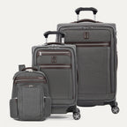 Set of gray suitcases with wheels  and a backpack on a white background