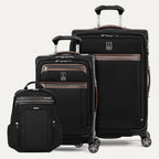 Set of black suitcases with brown accents  and a black backpack on a white background