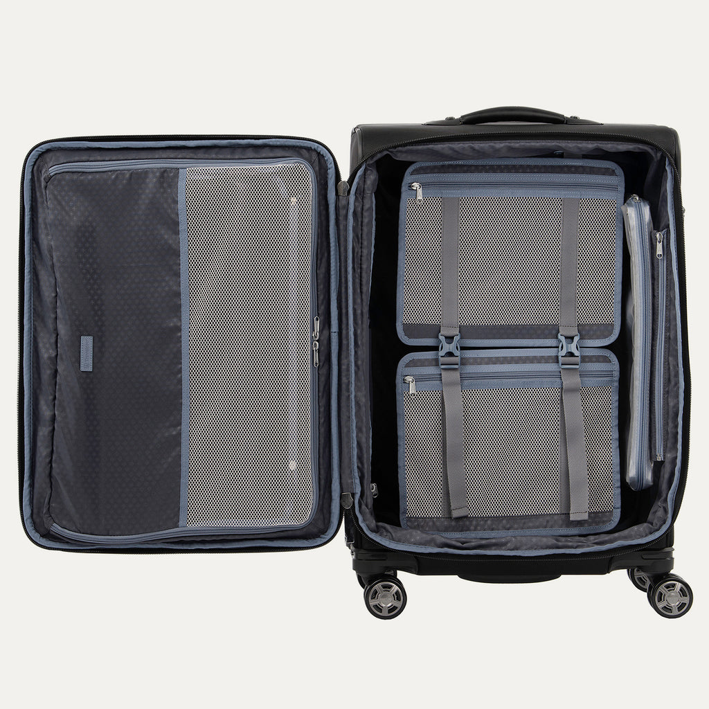 Open spinner suitcase with built-in organization including a fold-out suiter, accessory pockets, and adjustable hold-down straps.