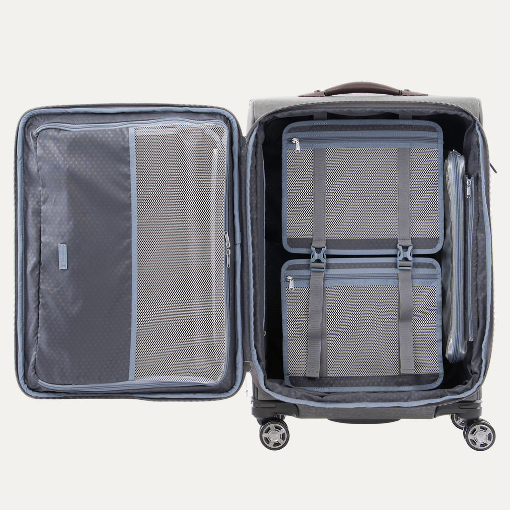 Open grey suitcases with built-in organization pockets and adjustable straps.
