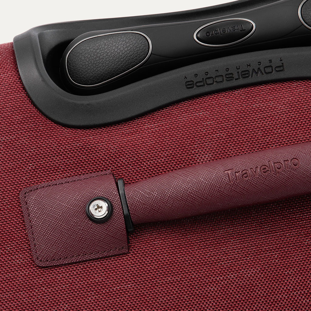 Close-up of a red suitcase handle 