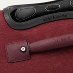 Close-up of a red suitcase handle 