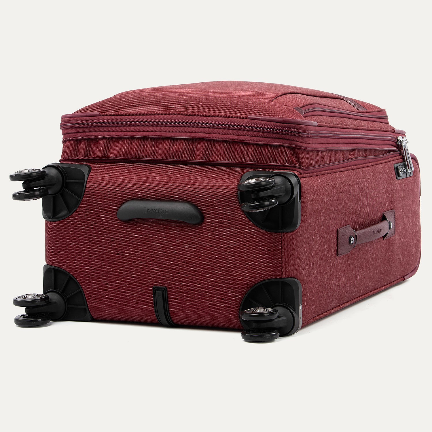 Red suitcase with black wheels on a white background