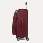 Red suitcase with wheels and handle on a white background