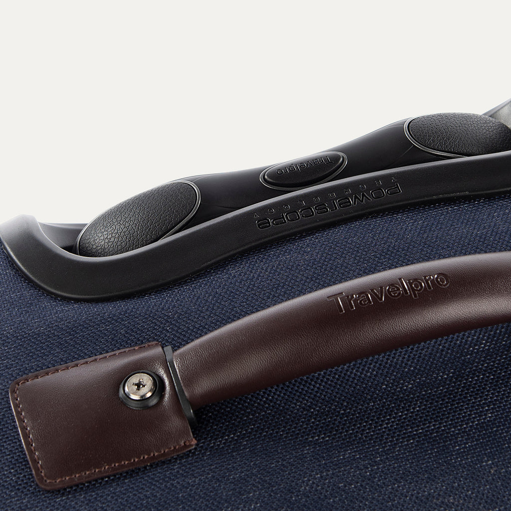 Close-up of a suitcase handle and grip on a blue suitcase.