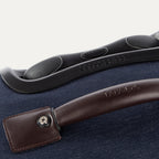 Close-up of a suitcase handle and grip on a blue suitcase.