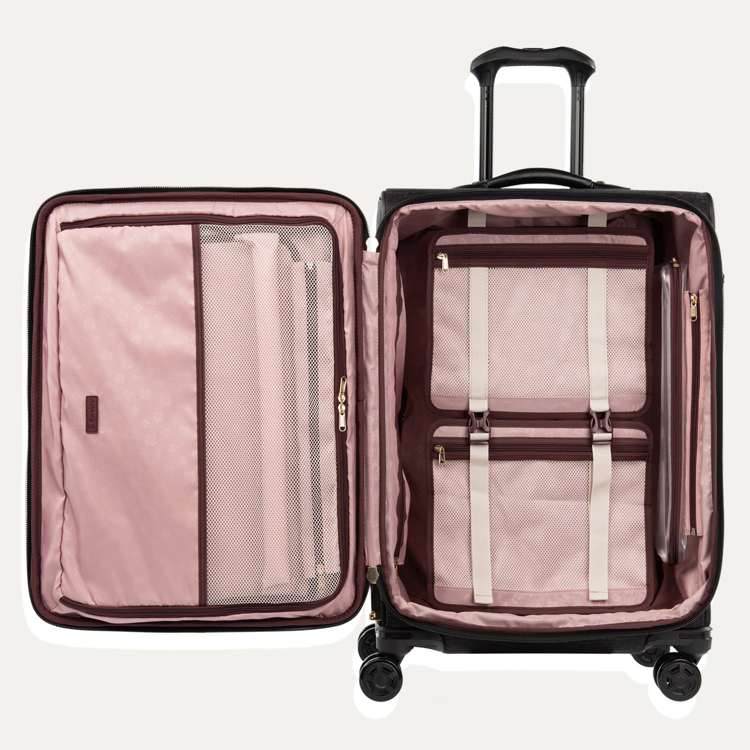 Black open suitcase with the interior compartments in pink interior with mesh pockets and a fold-out suiter