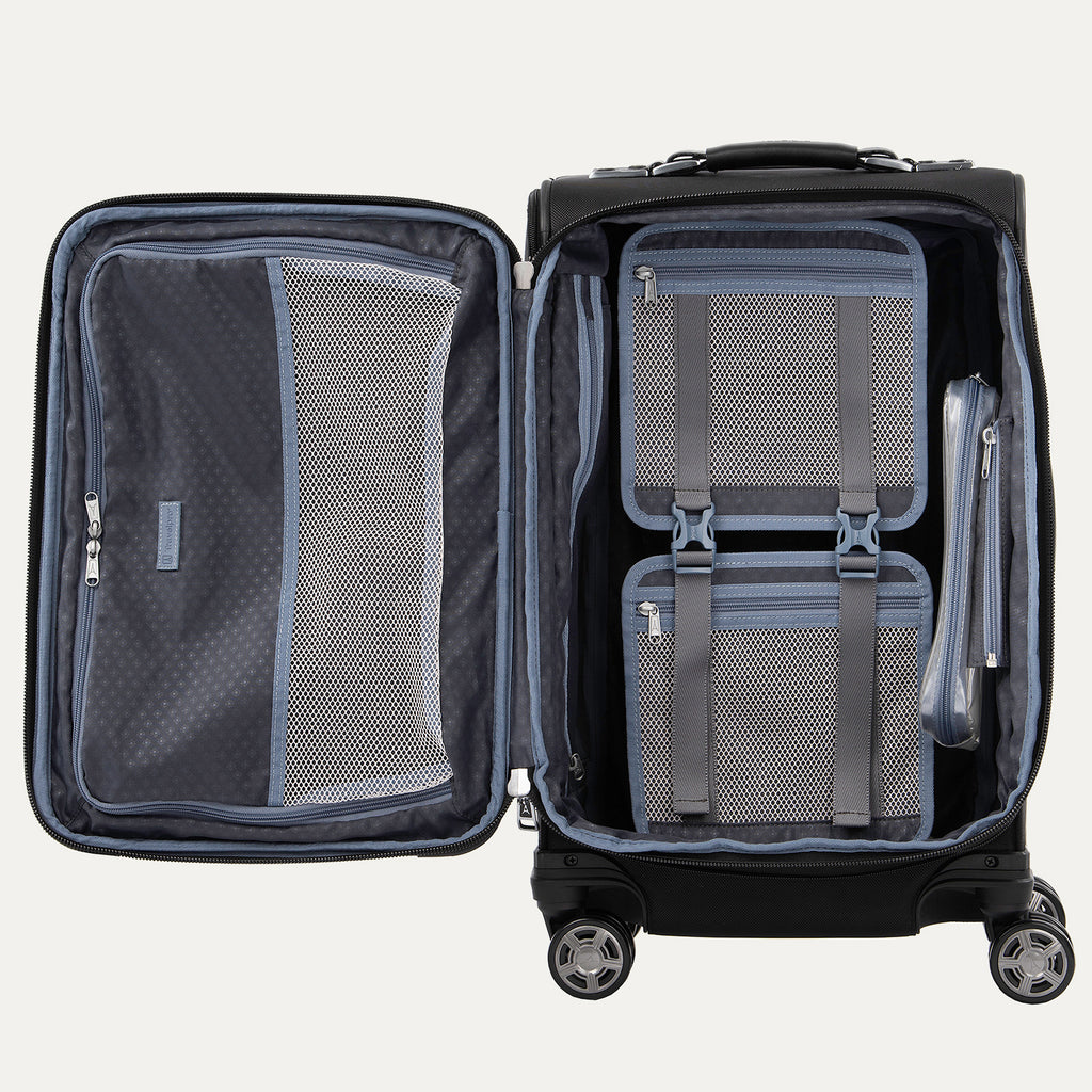 Interior view of the open Platinum Elite Carry-On Spinner in Shadow Black, showcasing the spacious split-case design with zippered mesh divider panels, a built-in fold-out suiter, and a TSA-compliant removable wet pocket.