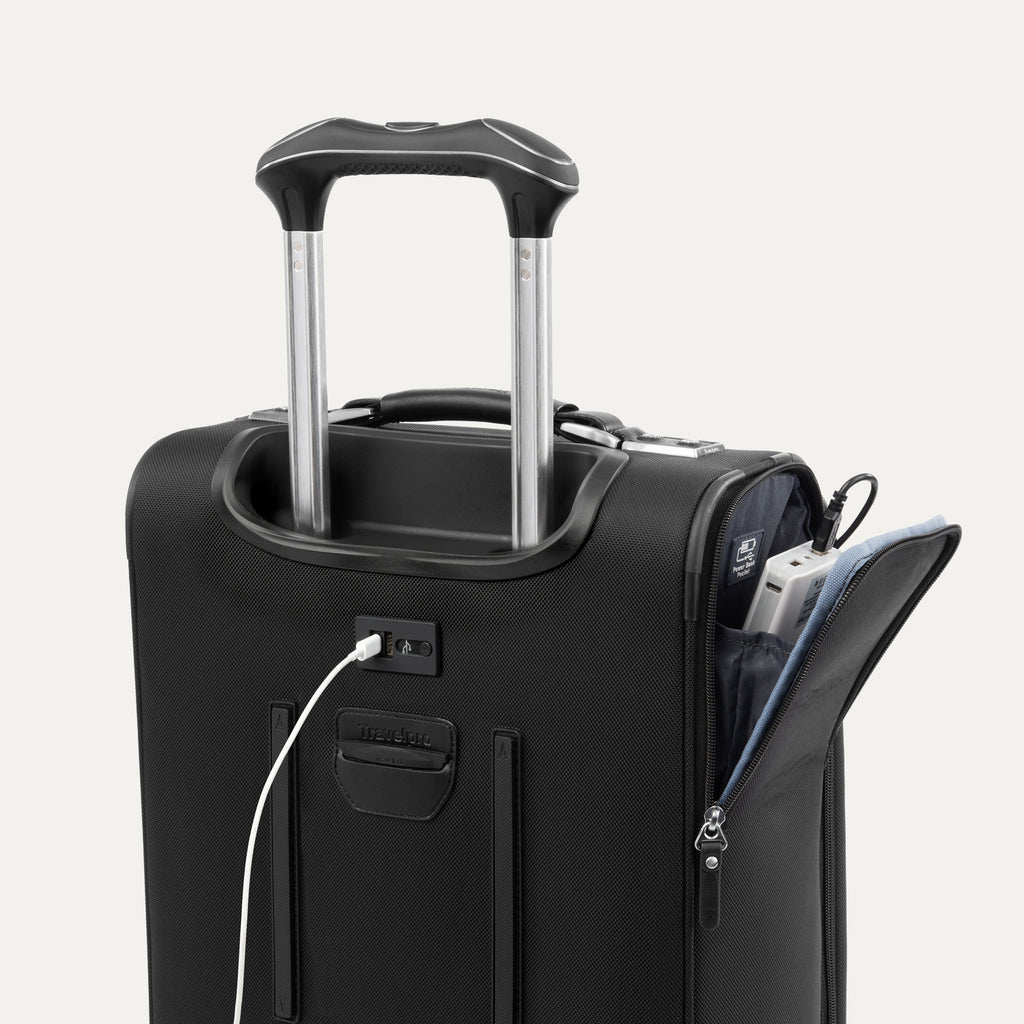 Close-up view of the Platinum Elite Carry-On Spinner in Shadow Black, highlighting the external USB port and dedicated interior power bank pocket for convenient charging on the go.