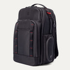 Three-quarter view of the Travelpro Altitude Large Backpack in Crimson Shadow, showcasing the sleek, durable exterior, organized front compartments, and modern design suited for both professional and travel use.