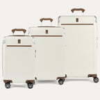 Set of three cream-colored suitcases with brown handles and wheels on a white background