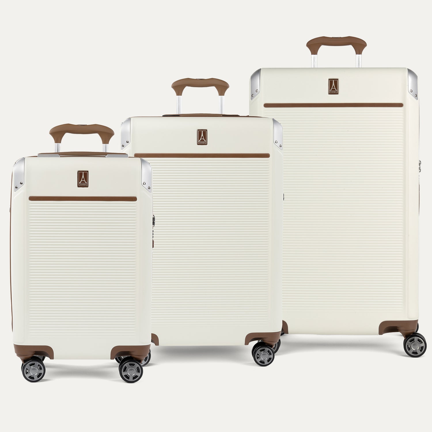 Set of three cream-colored suitcases with brown handles and wheels on a white background