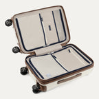 Open beige suitcase with brown accents on a white background