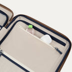 Open travel case with toiletries on a white background