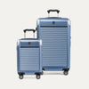 Two blue suitcases of different sizes on a white background