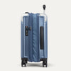 Side view of blue suitcase with a handle and wheels on a white background