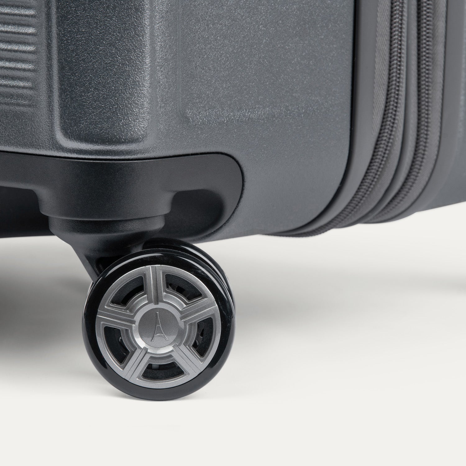 Close-up of a suitcase wheel on a white background