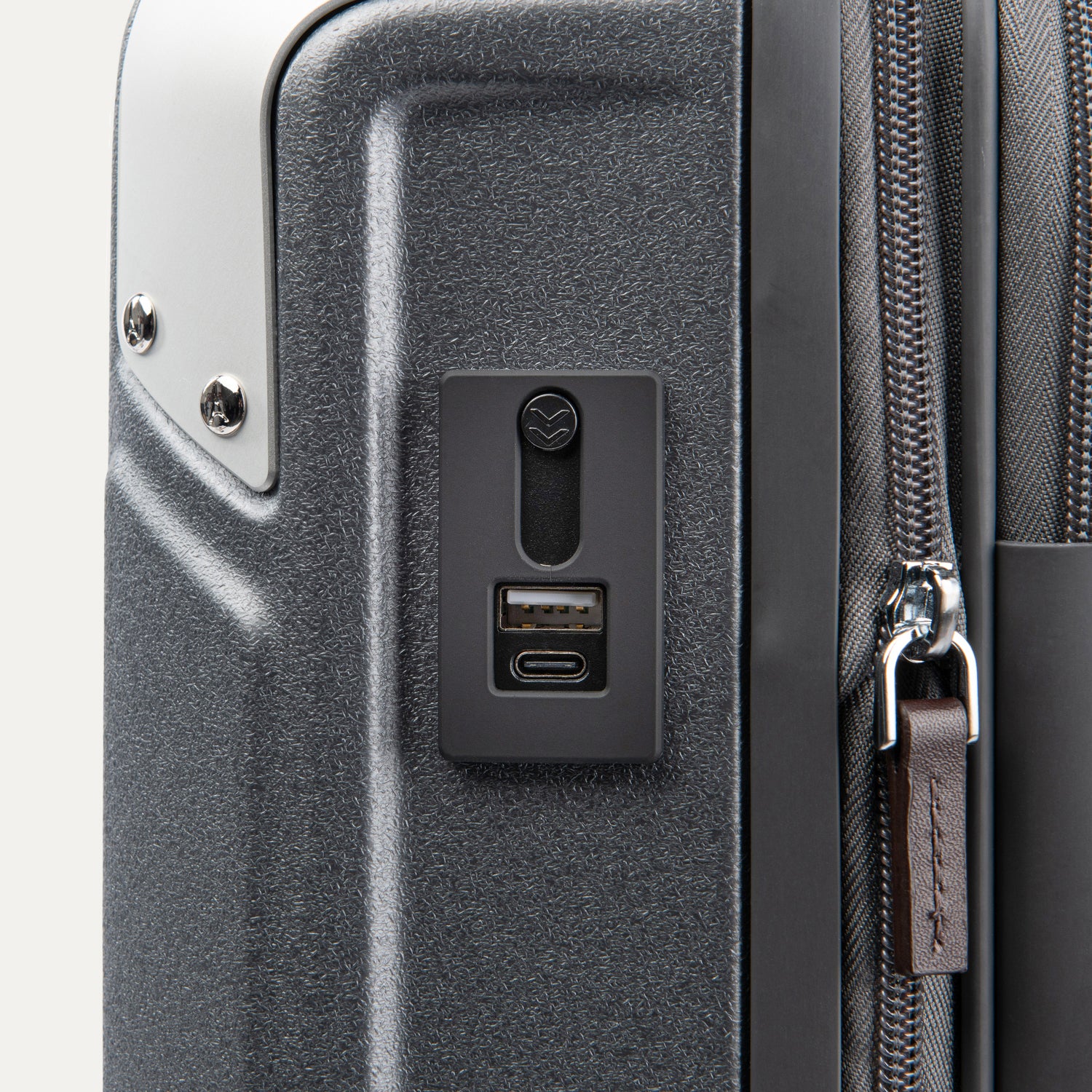 Close-up of Travelpro Platinum Elite Hardside Spinner in Vintage Grey, showing integrated USB A and C Charging Port with protective cover.