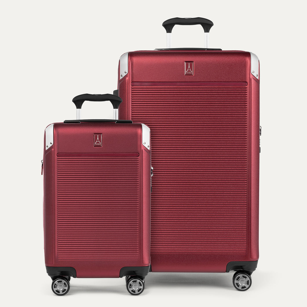 A set of two red hardside spinner suitcases, one carry-on and one check-in size, with the travelpro logo visible