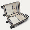 Interior view of Travelpro Platinum Elite Hardside Spinner in Metallic Sand, featuring zippered divider panels and organizational compartments.
