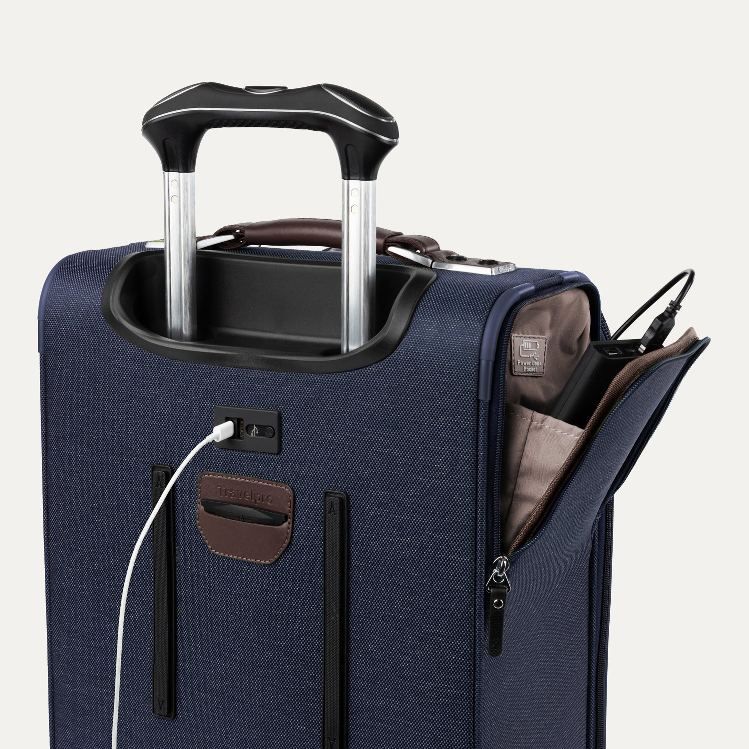 Close-up of blue suitcase with extended handle and visible USB charging cable, on white background