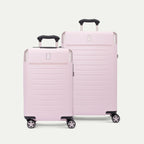 Three-quarter front view of the Travelpro Platinum Elite Next Gen Carry-On & Medium Powder Pink Suitcases, featuring two hardshell spinner suitcases in a matching light pink finish with leather accents, telescoping extension handles, and smooth-rolling multi-directional spinner wheels against a clean off-white background.