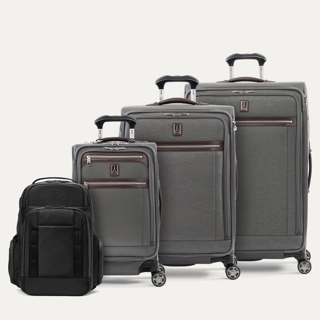 Set of gray suitcases and a black backpack on a white background
