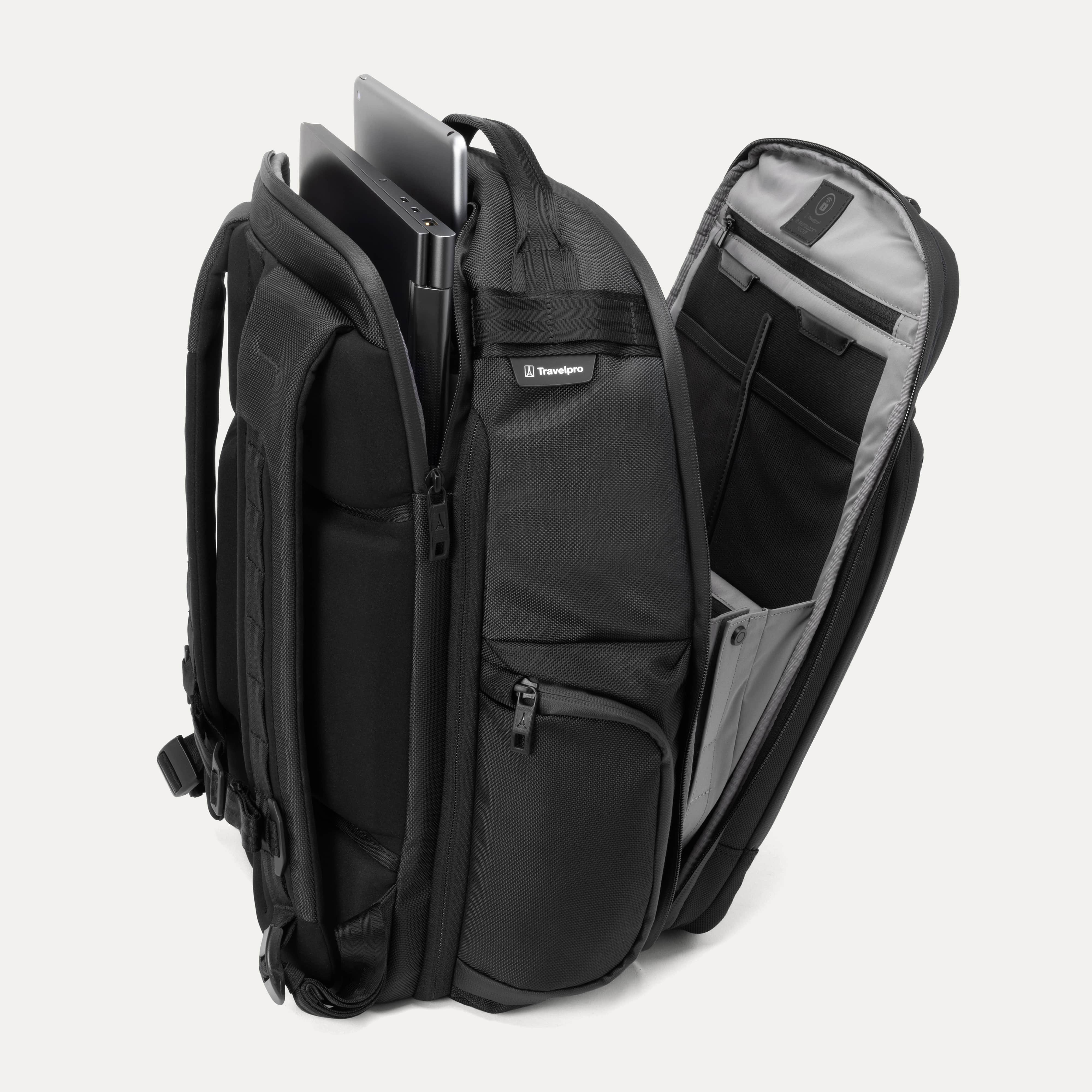 Black backpack with multiple compartments open on a white background