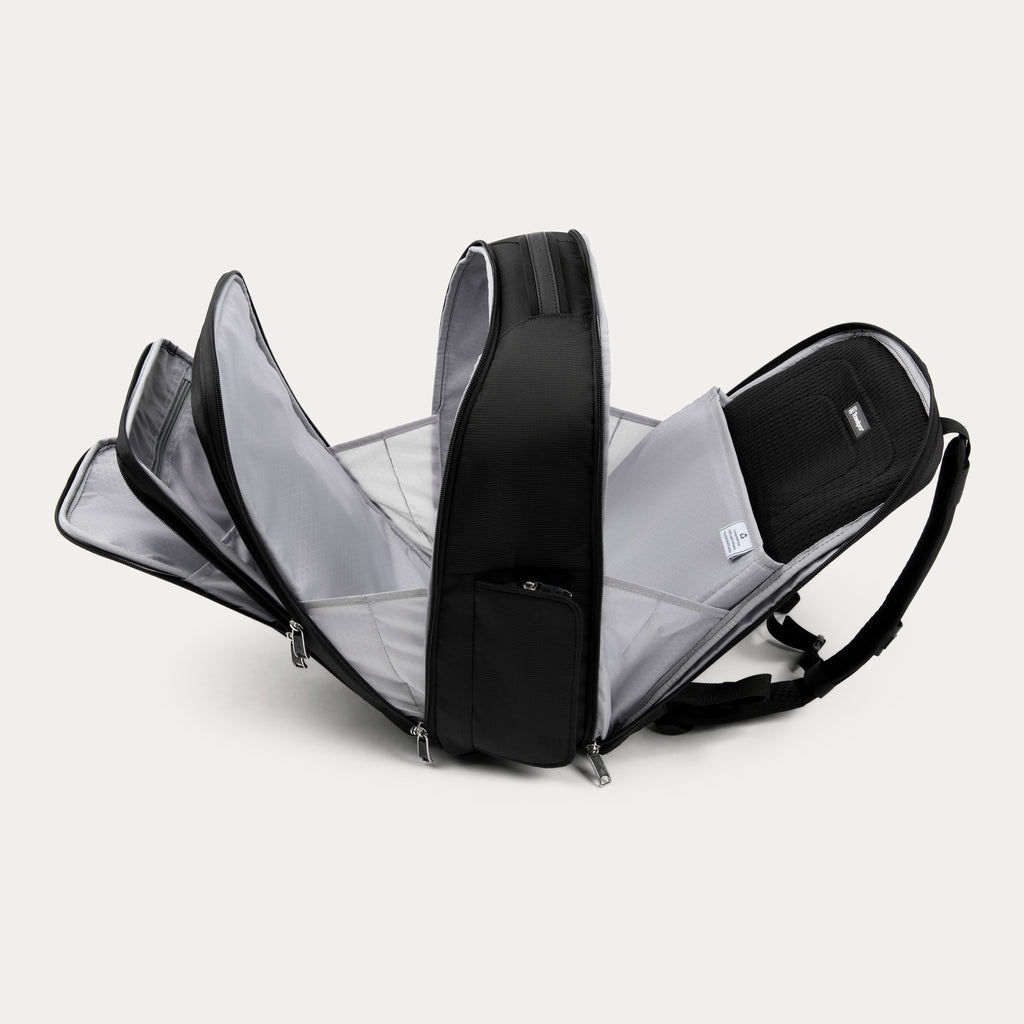 Black backpack with all the compartments open on a white background 