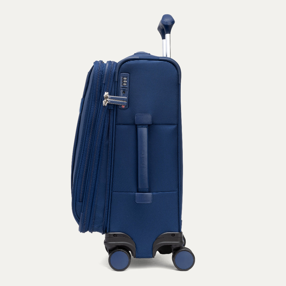 Blue suitcase with wheels on a light gray background