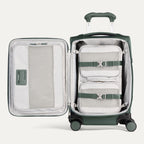 Green suitcase with open compartment showing packing cubes on a light gray background
