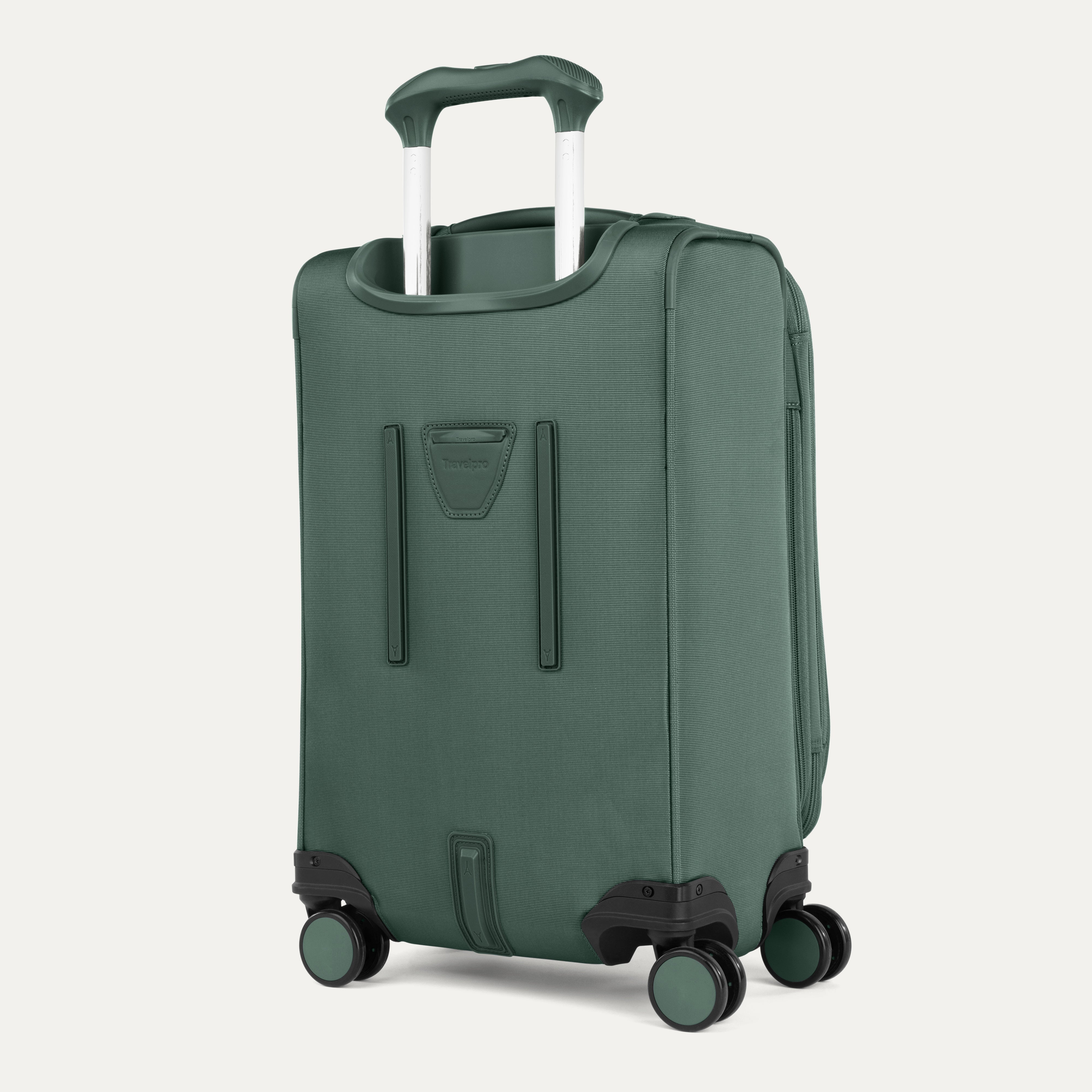 Green suitcase with wheels and handle on a light gray background