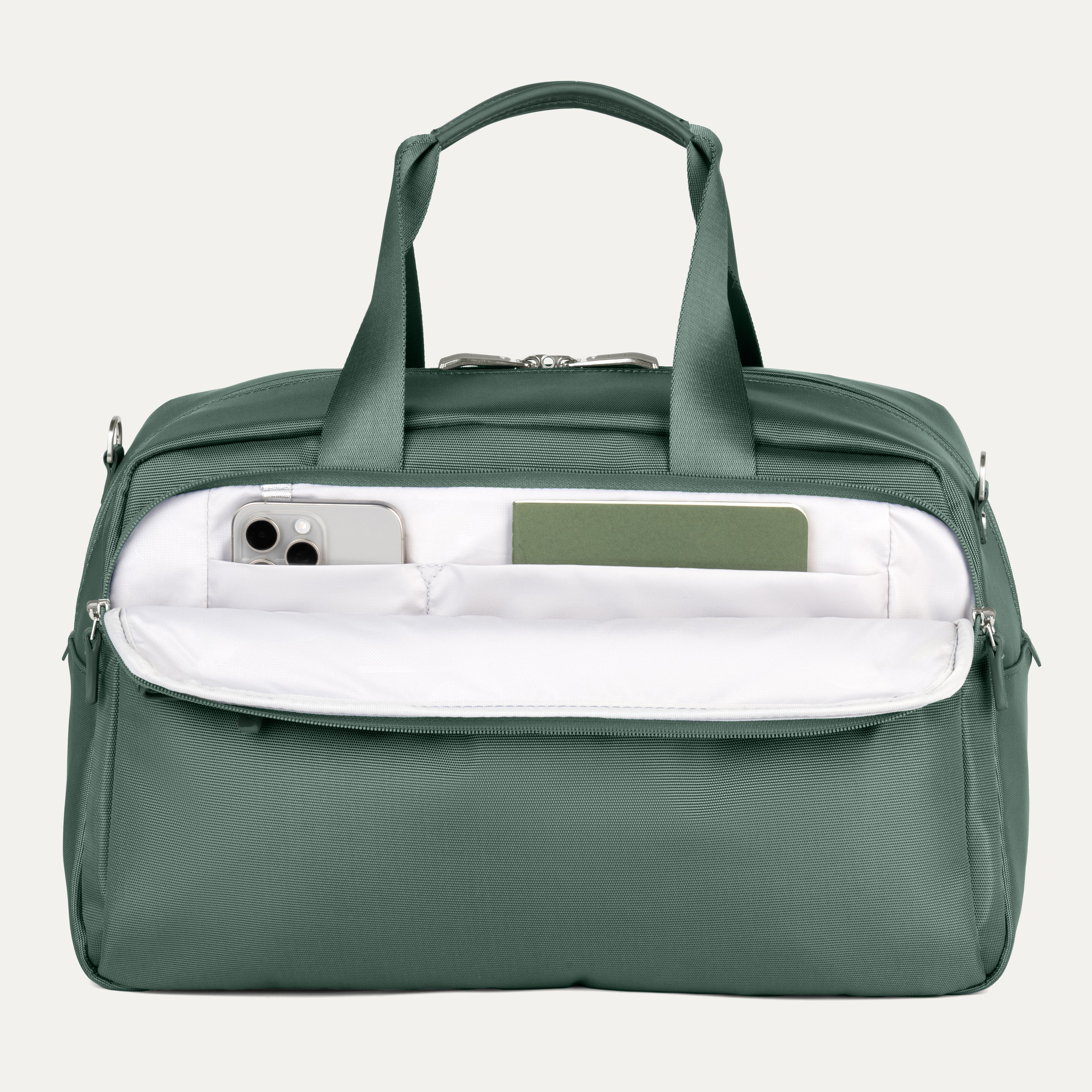 Green travel bag with a white interior pocket showcasing phone and notebook on a light gray background