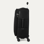 Side view of black suitcase with handle and wheels on a white a background 