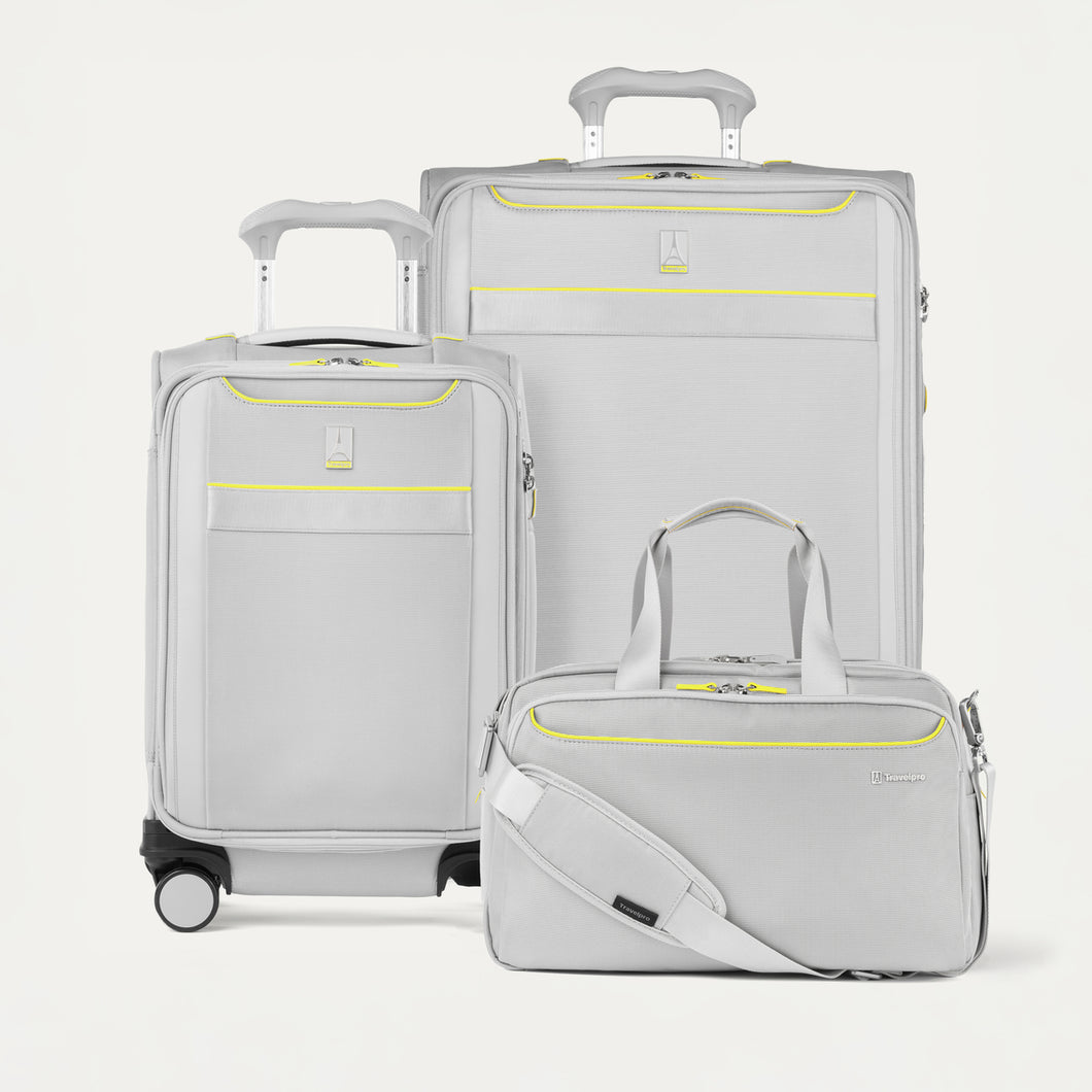 Set of gray suitcases with yellow accents on a white background