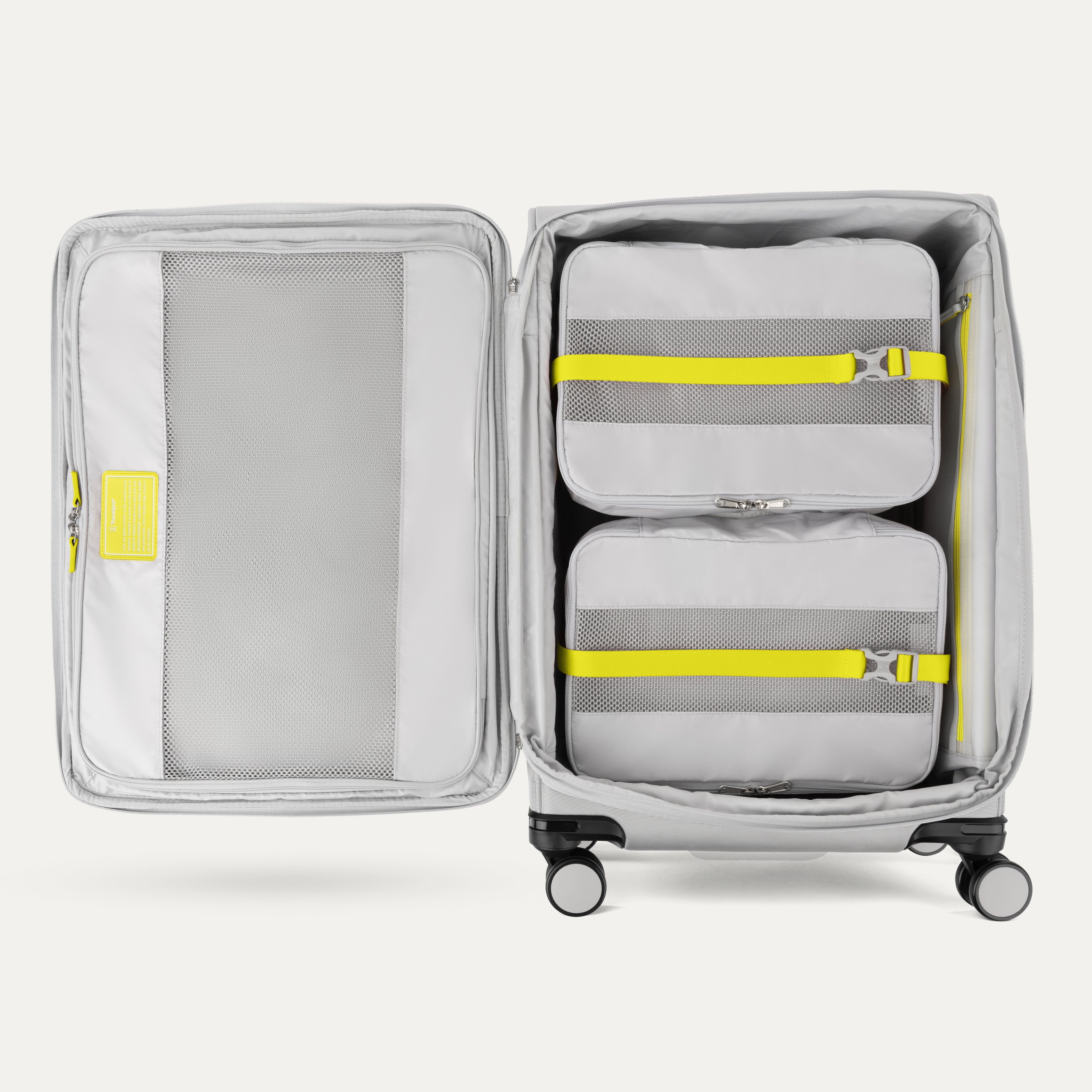 Open suitcase with packing cubes inside on a white background