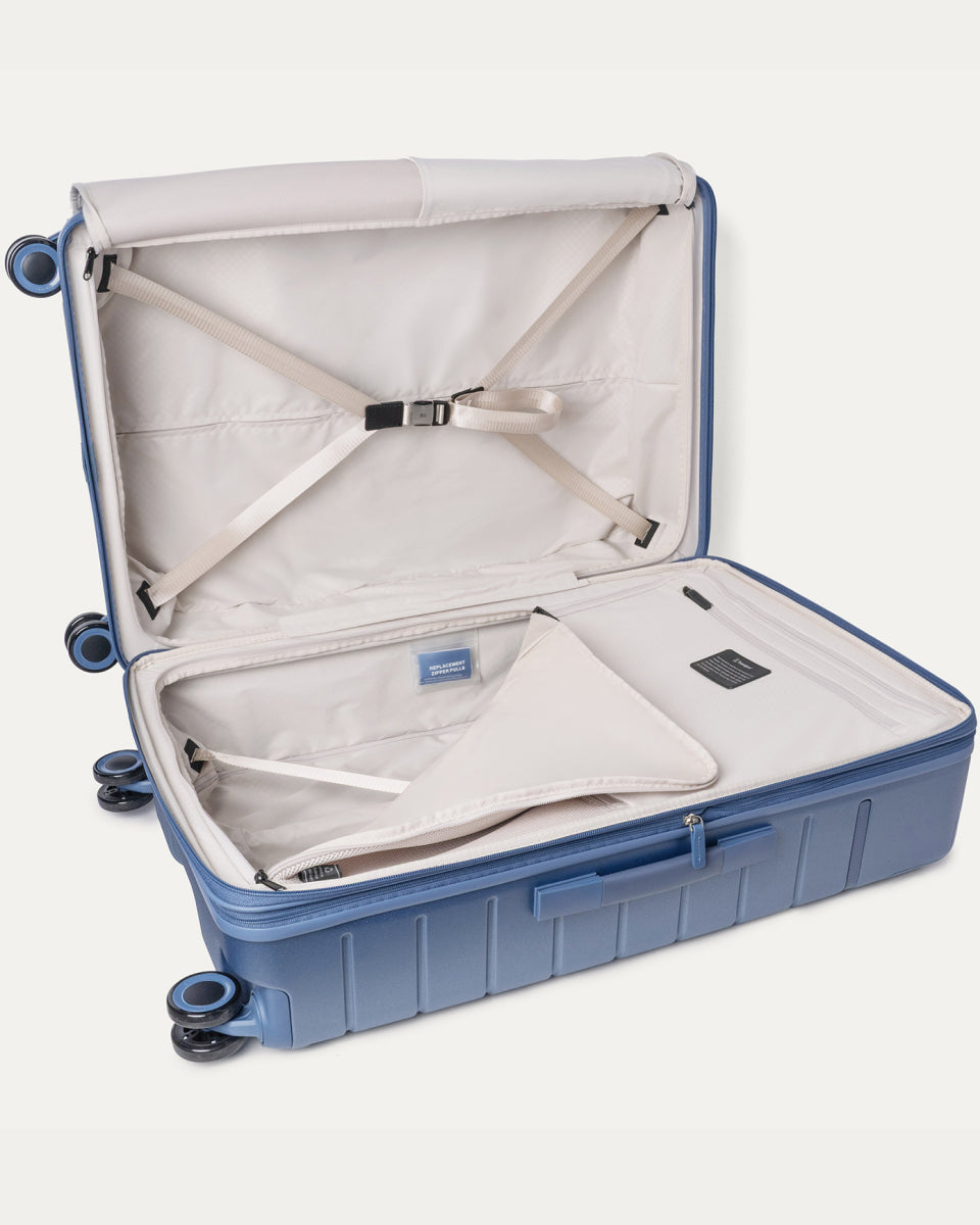Open interior of the Large Check-In from the Travelpro Platinum Reserve Compact Carry-On / Large Check-In Hardside Set in Steel Blue with hold-down straps