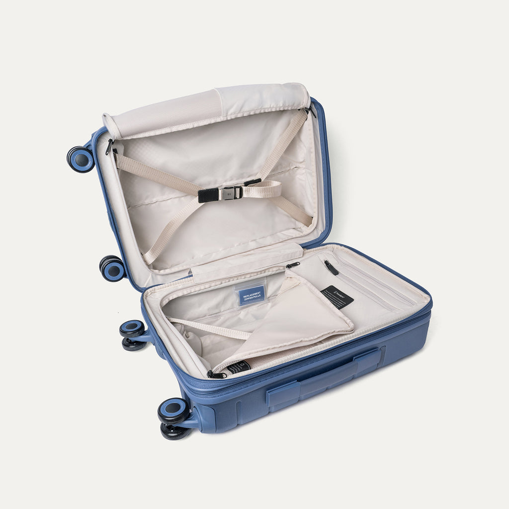 Open interior of the Compact Carry-On from the Travelpro Platinum Reserve Compact Carry-On / Large Check-In Hardside Set in Steel Blue with hold-down straps