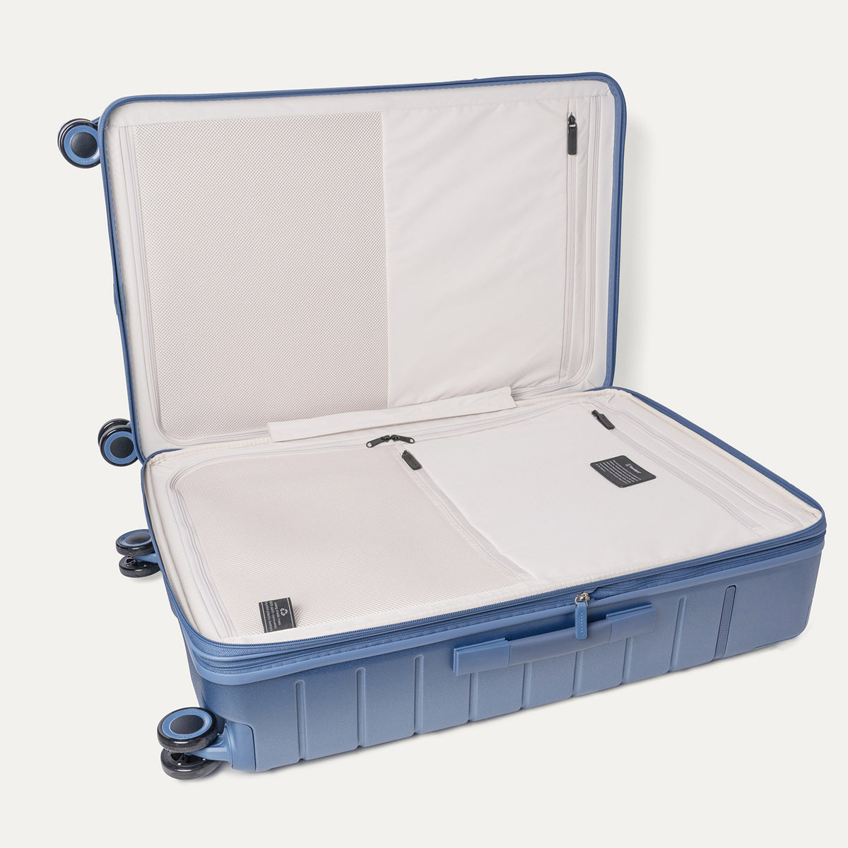 Open interior of the Large Check-In from the Travelpro Platinum Reserve Compact Carry-On / Large Check-In Hardside Set in Steel Blue showing the zippered divider panel