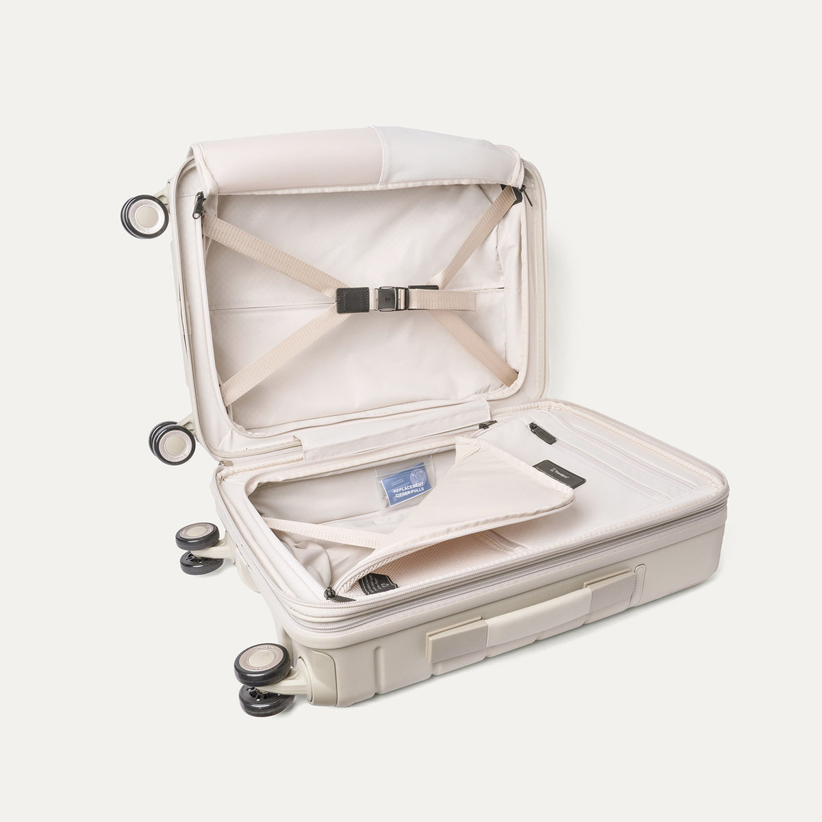 Open interior of the Compact Carry-On from the Travelpro Platinum Reserve Compact Carry-On / Medium Check-In Hardside Set in Sandstone with hold-down straps