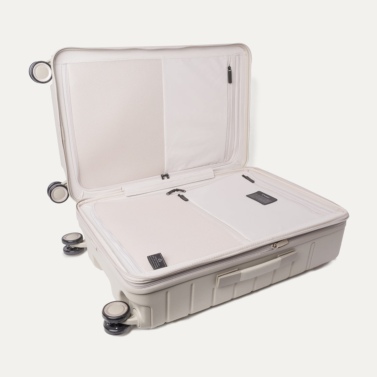Open interior of the Medium Check-In from the Travelpro Platinum Reserve Compact Carry-On / Medium Check-In Hardside Set in Sandstone showing the zippered divider panel