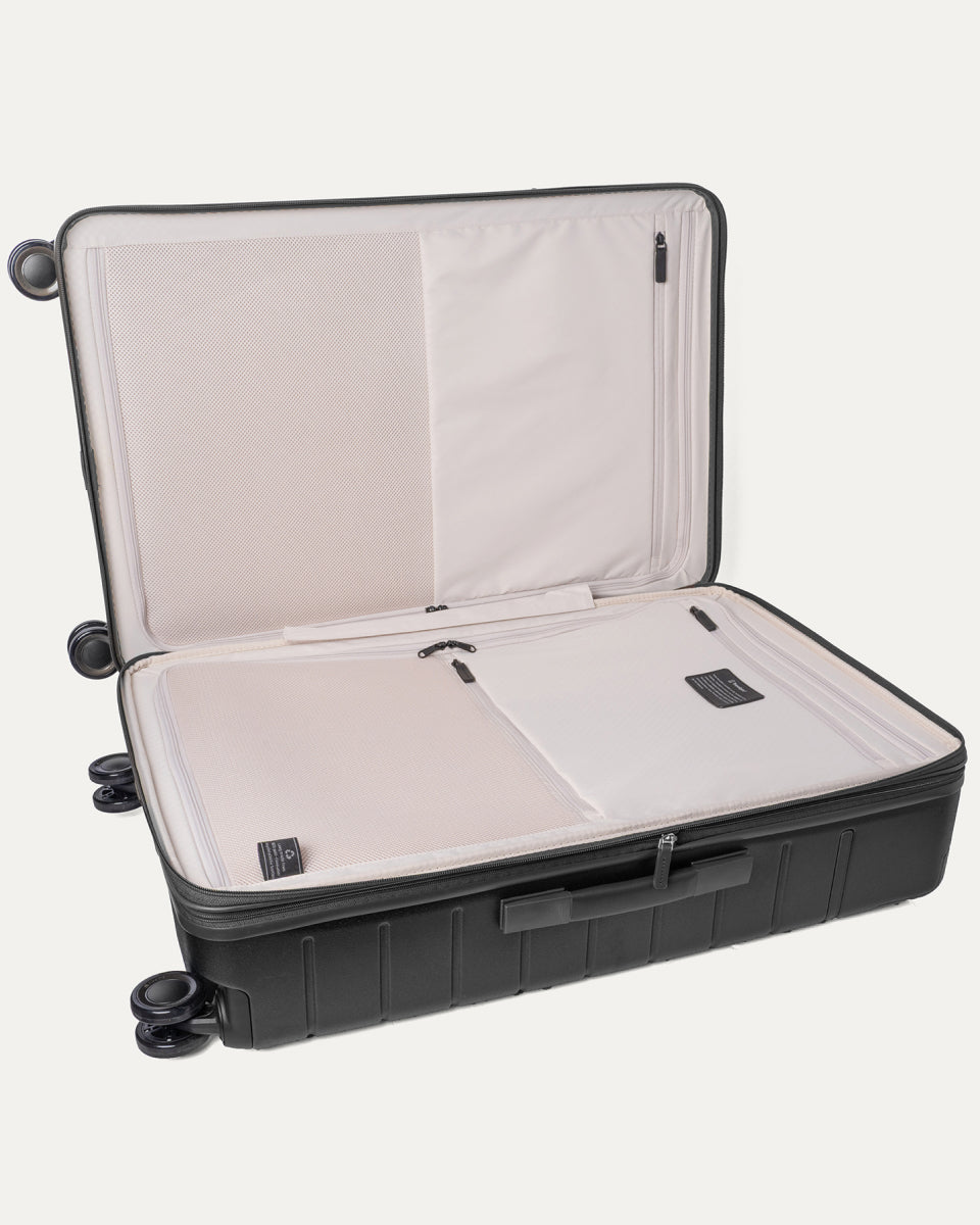 Open interior of the Large Check-In from the Travelpro Platinum Reserve Carry-On / Large Check-In Hardside Set in Black Dust showing the zippered divider panel