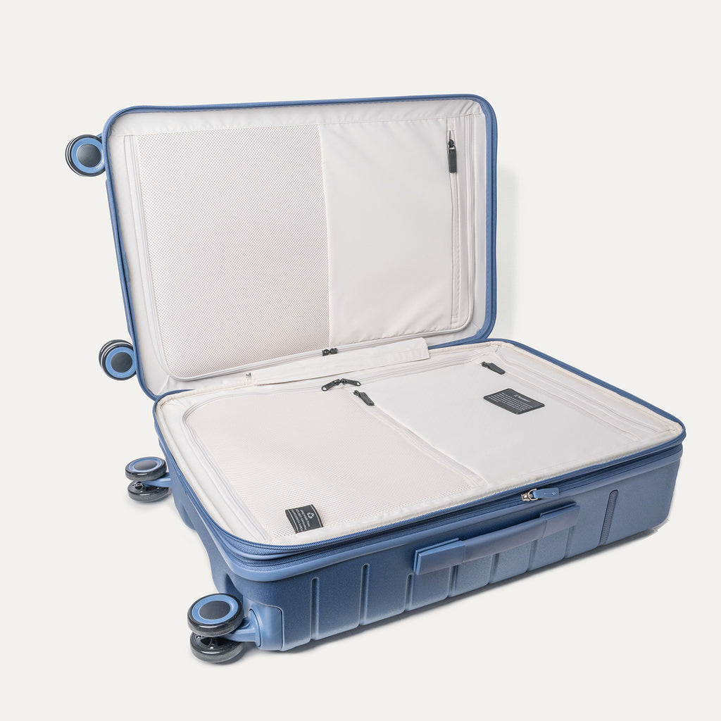 Open interior of the Medium Check-In from the Travelpro Platinum Reserve Carry-On / Medium / Large Hardside Set in Steel Blue showing the zippered divider panel