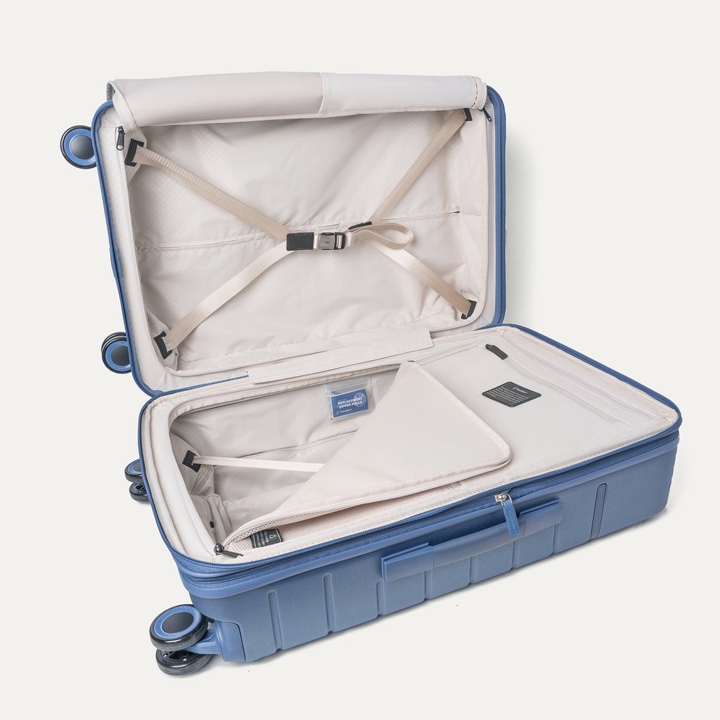 Open interior of the Medium Check-In from the Travelpro Platinum Reserve Carry-On / Medium / Large Hardside Set in Steel Blue with hold-down straps