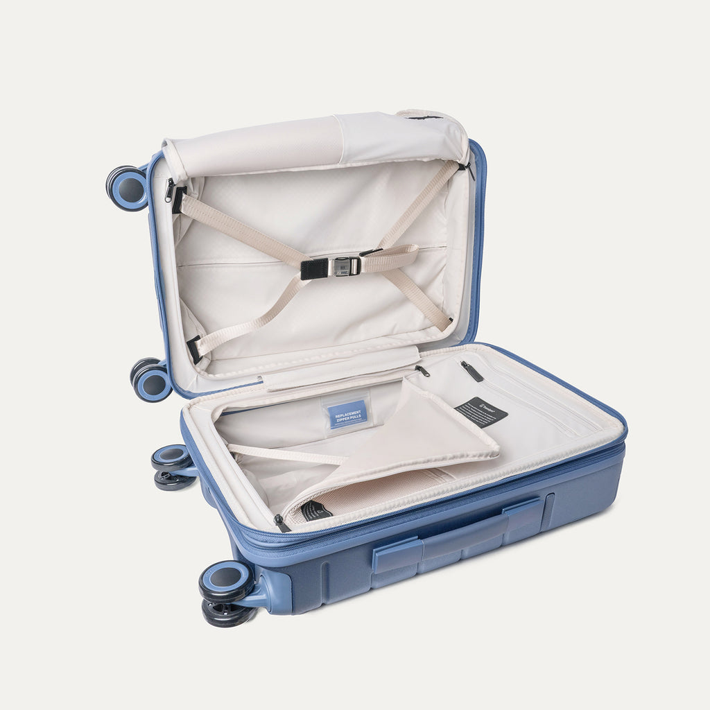 Open interior of the Carry-On from the Travelpro Platinum Reserve Carry-On / Medium Check-In Hardside Set in Steel Blue with hold-down straps