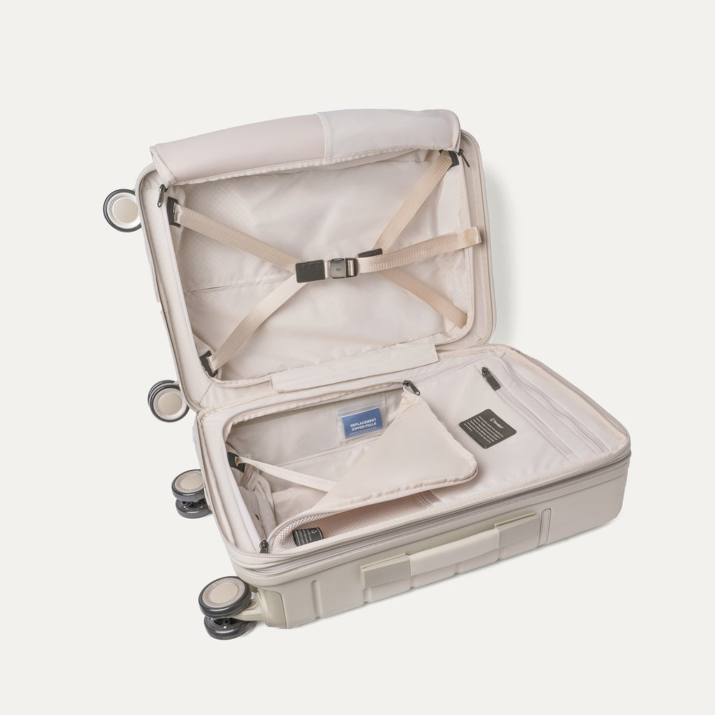 Open interior of the Carry-On from the Travelpro Platinum Reserve Carry-On / Large Check-In Hardside Set in Sandstone with hold-down straps