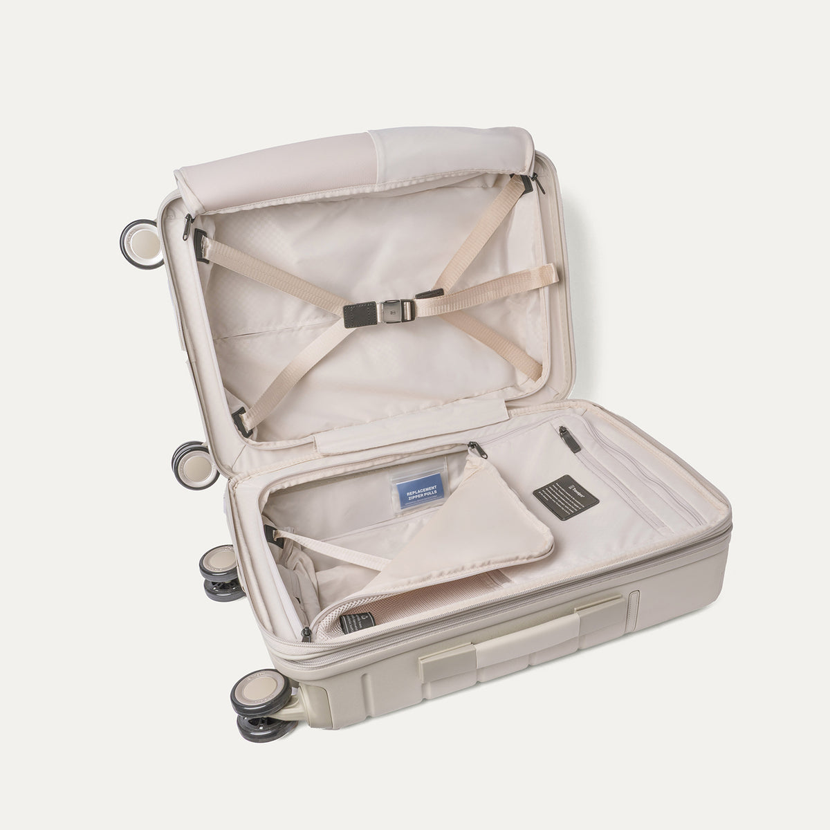 Open interior of the Carry-On from the Travelpro Platinum Reserve Carry-On / Large Check-In Hardside Set in Sandstone with hold-down straps