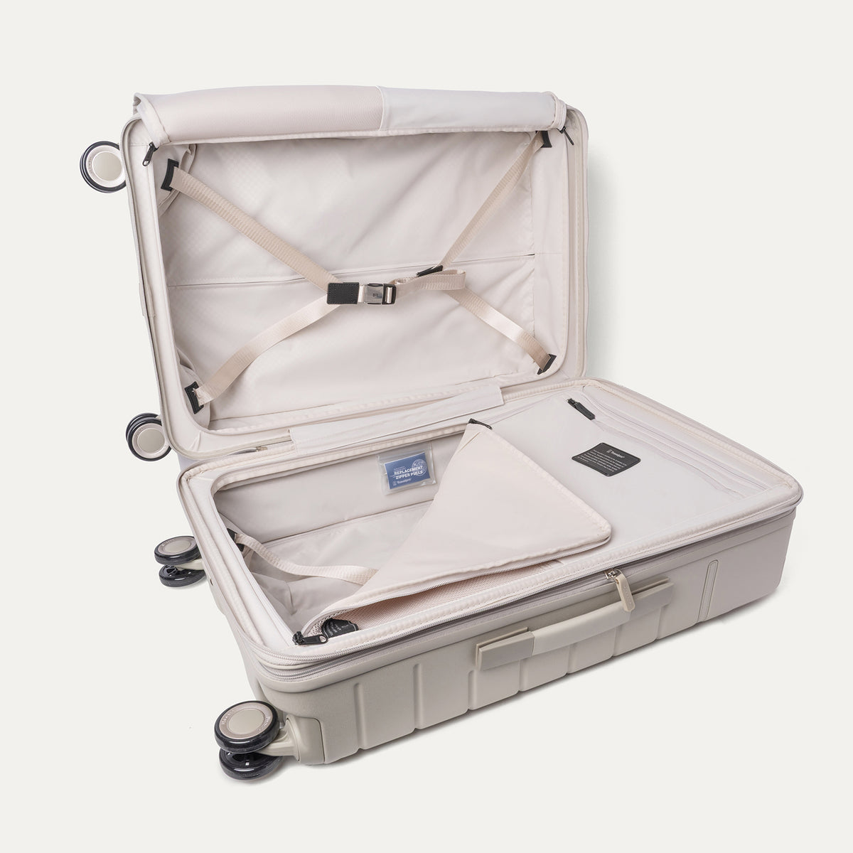 Open interior of the Medium Check-In from the Travelpro Platinum Reserve Carry-On / Medium Check-In Hardside Set in Sandstone with hold-down straps