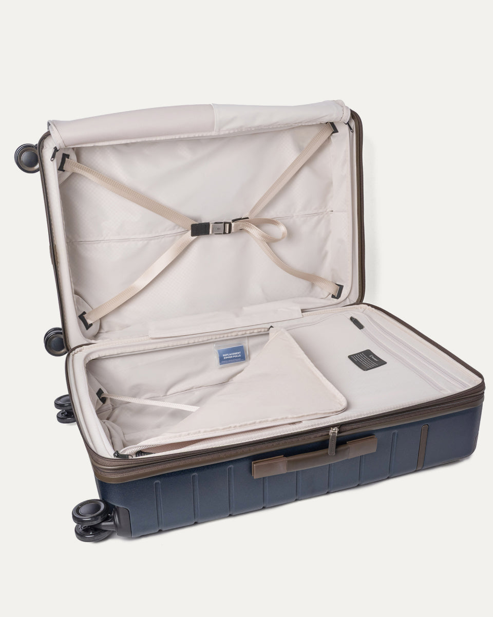 Open interior of the Large Check-In from the Travelpro Platinum Reserve Carry-On / Medium / Large Hardside Set in Midnight Trail with hold-down straps