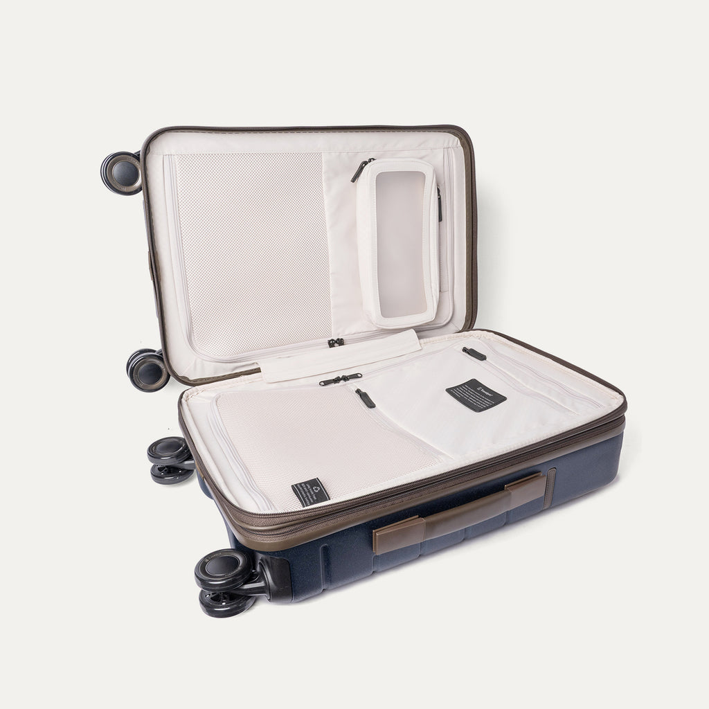 Open interior of the Carry-On from the Travelpro Platinum Reserve Carry-On / Medium / Large Hardside Set in Midnight Trail showing the zippered divider panel